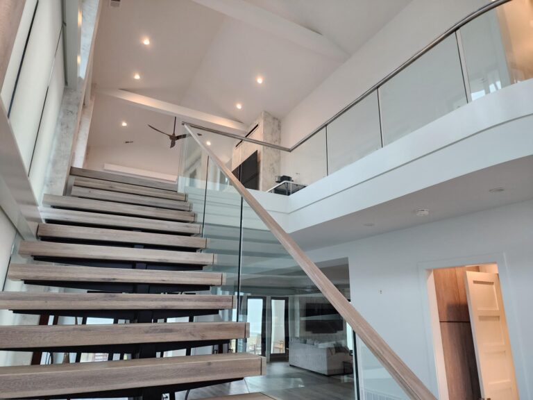 custom staircases designs for offices or homes with a modern glass stair railing
