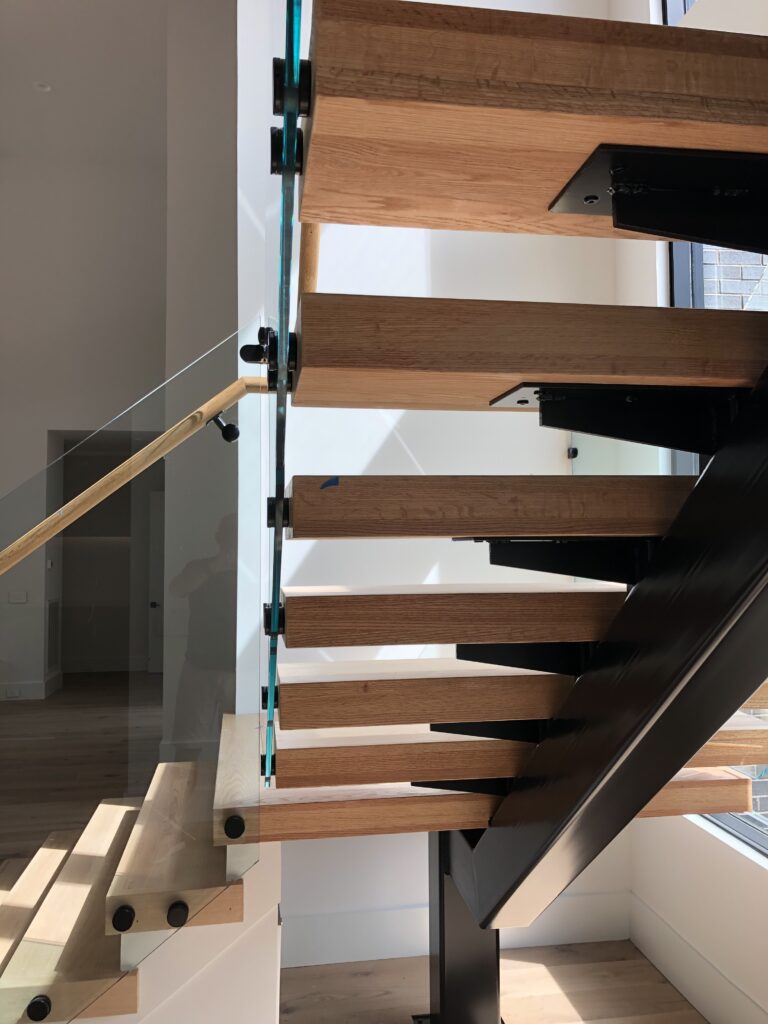 single beam staircases designs with a modern glass stair railing
