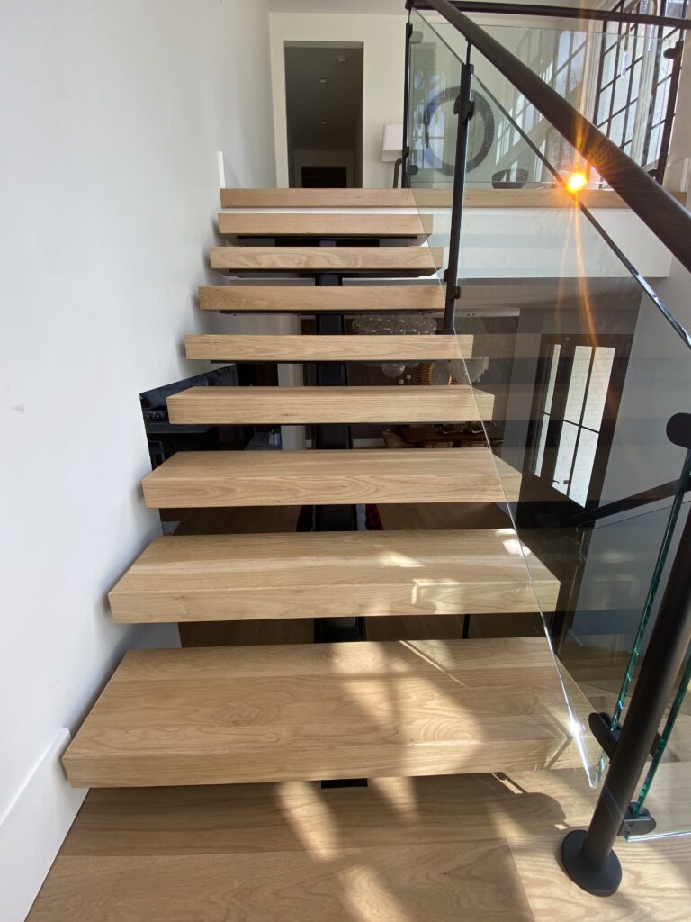 stairway designs with thick wooden treads and glass balustrade